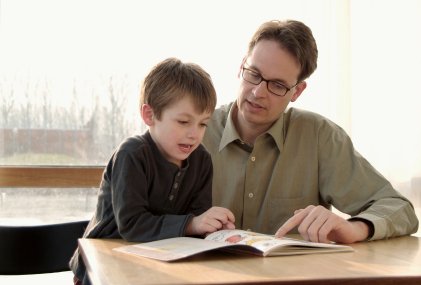 father and son reading a book